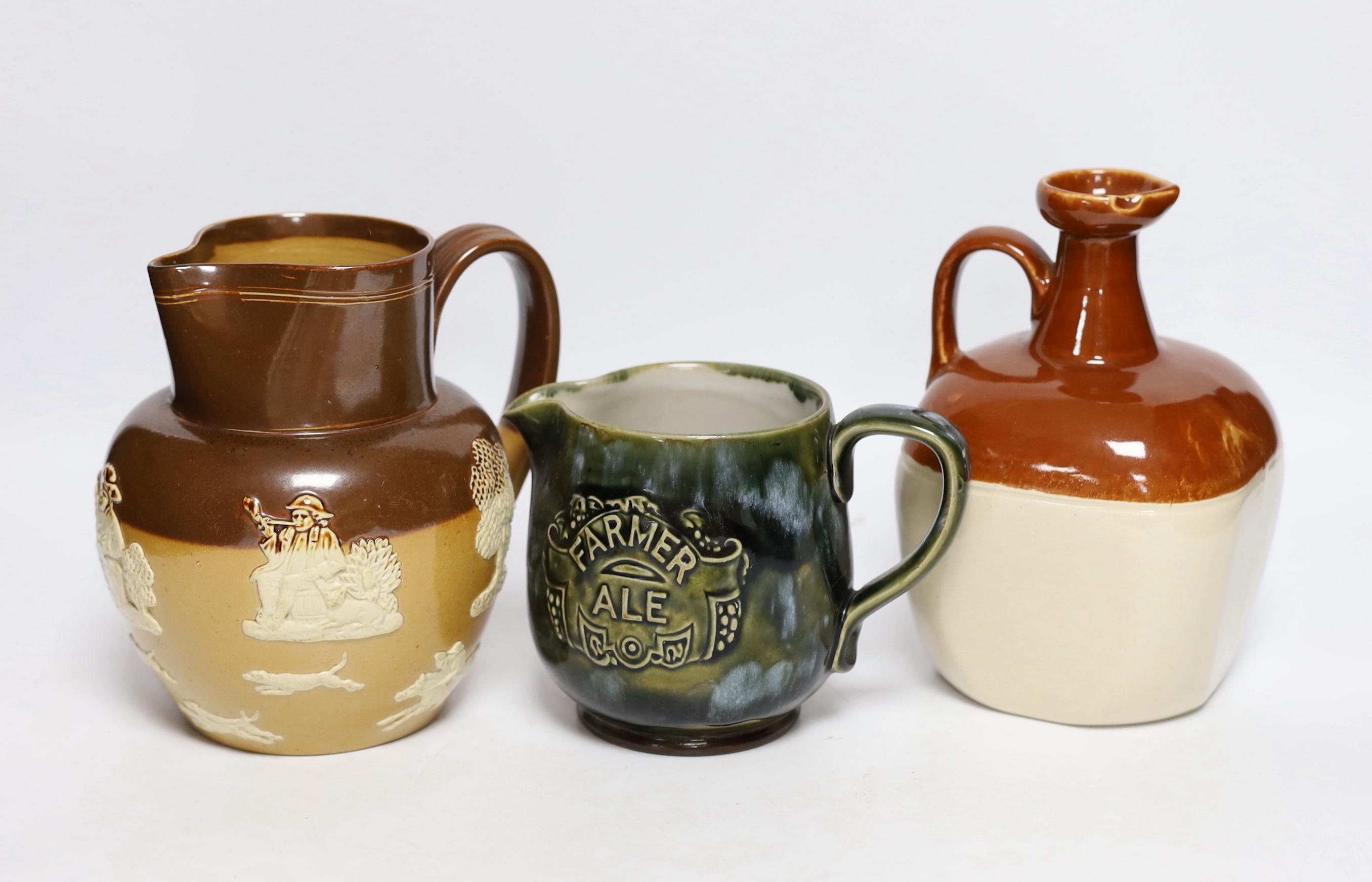 Two Doulton stoneware jugs and a Long John whisky ewer, largest 17cm high